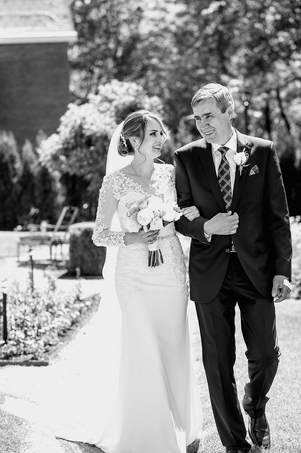 Father of the bride walking her down the aisle.